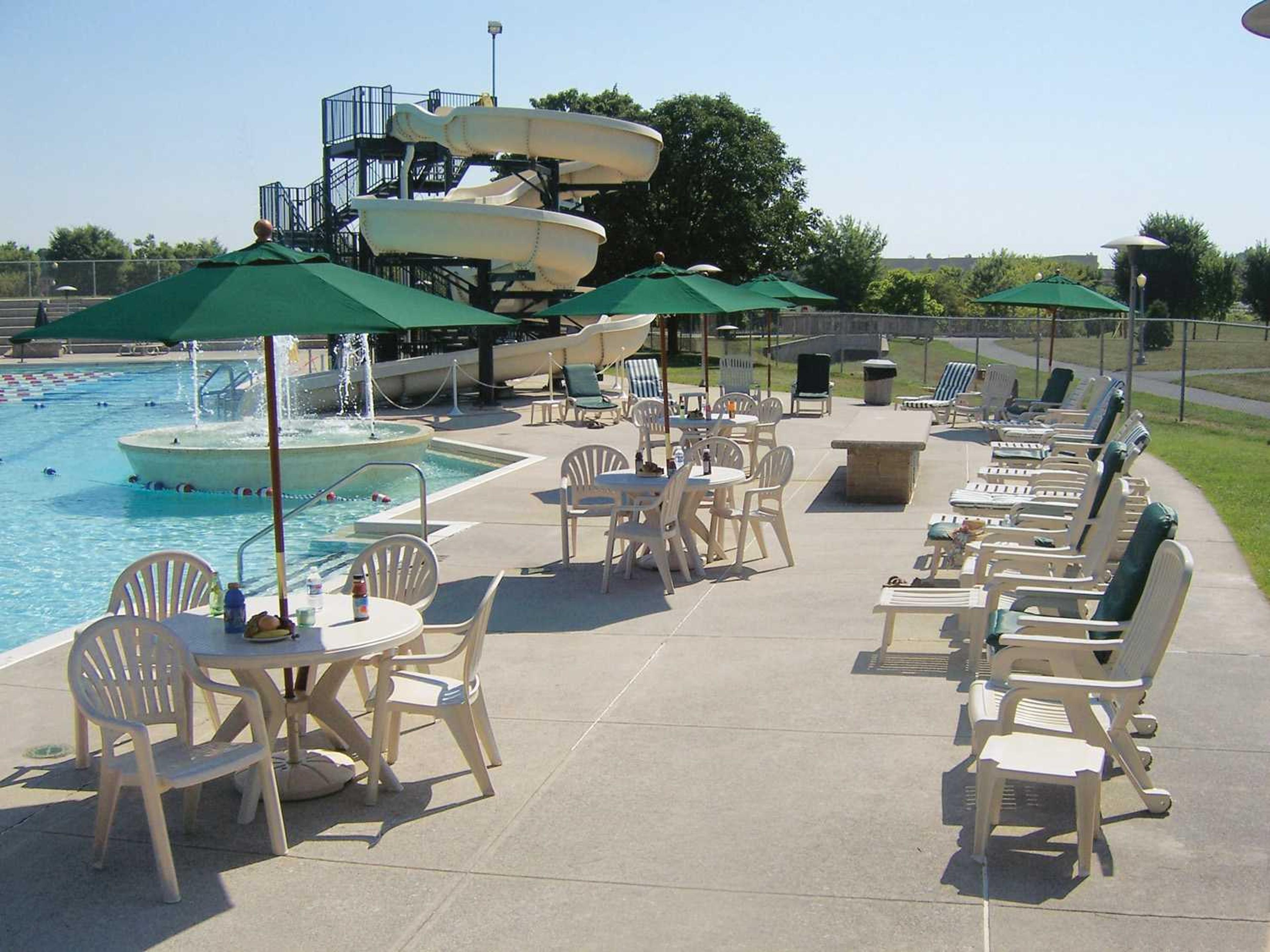 Grosfillex Pacific Fanback Resin Sand Stacking Outdoor Patio Dining Arm Chair