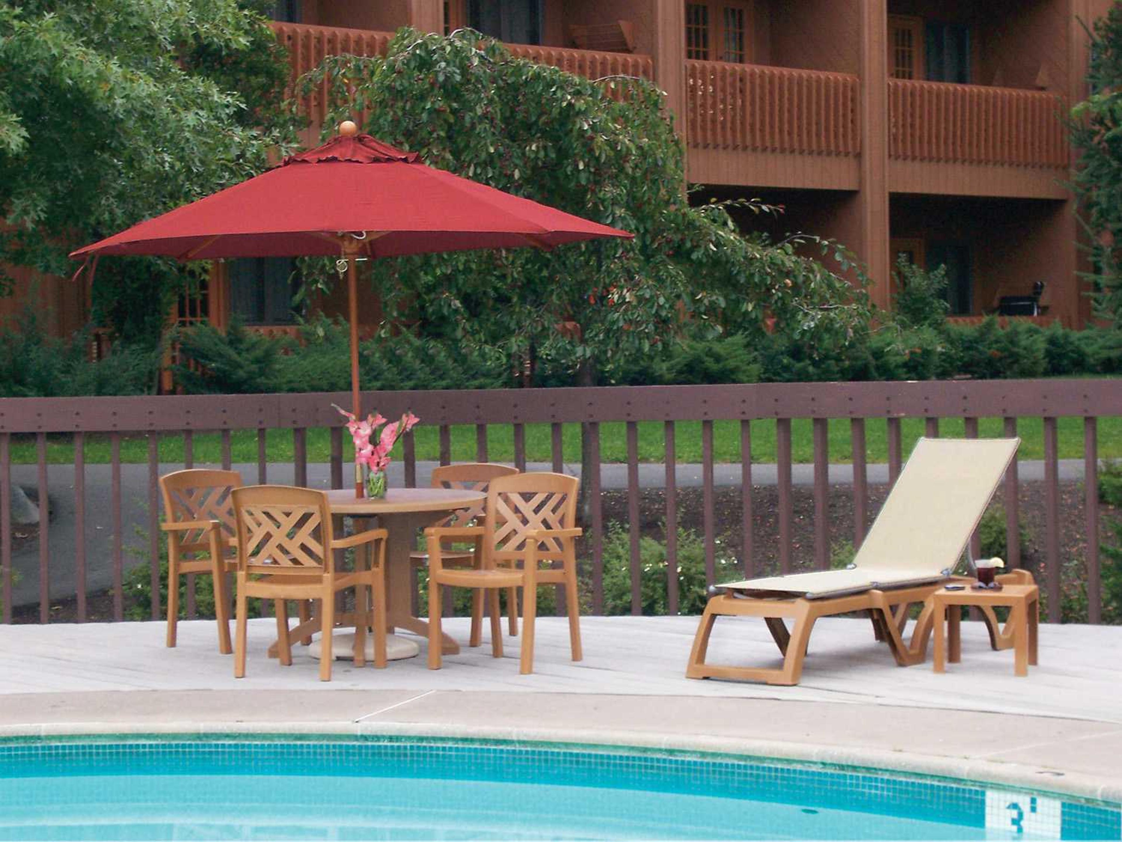 Grosfillex Sanibel Resin Teakwood Stacking Patio Dining Arm Chair